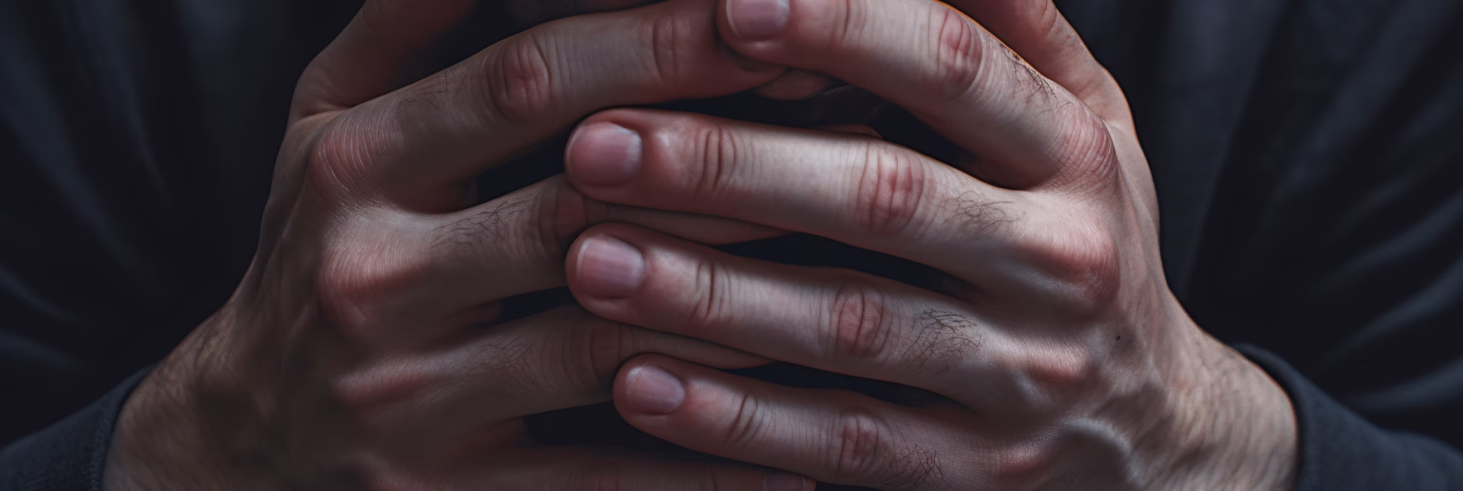 Clasped hands of a service member under stress